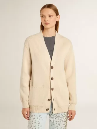 Beige damkofta med texten ”Golden” på ryggen