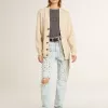 Beige damkofta med texten ”Golden” på ryggen Beige damkofta med texten ”Golden” på ryggen