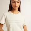 Dam-T-shirt i åldrad vit bomull med tryck och broderi