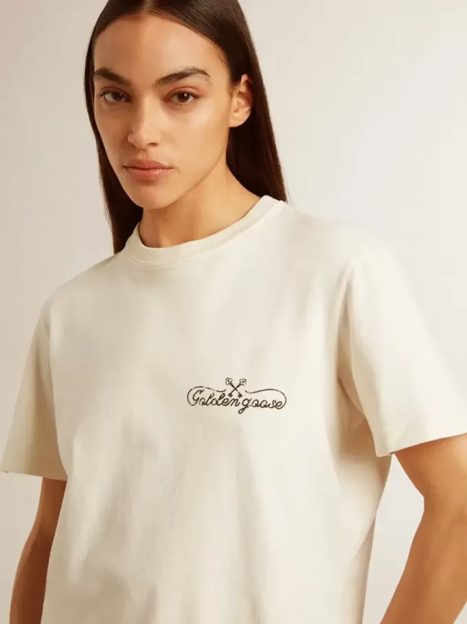 Dam-T-shirt i åldrat vitt med logotyp på bröstet