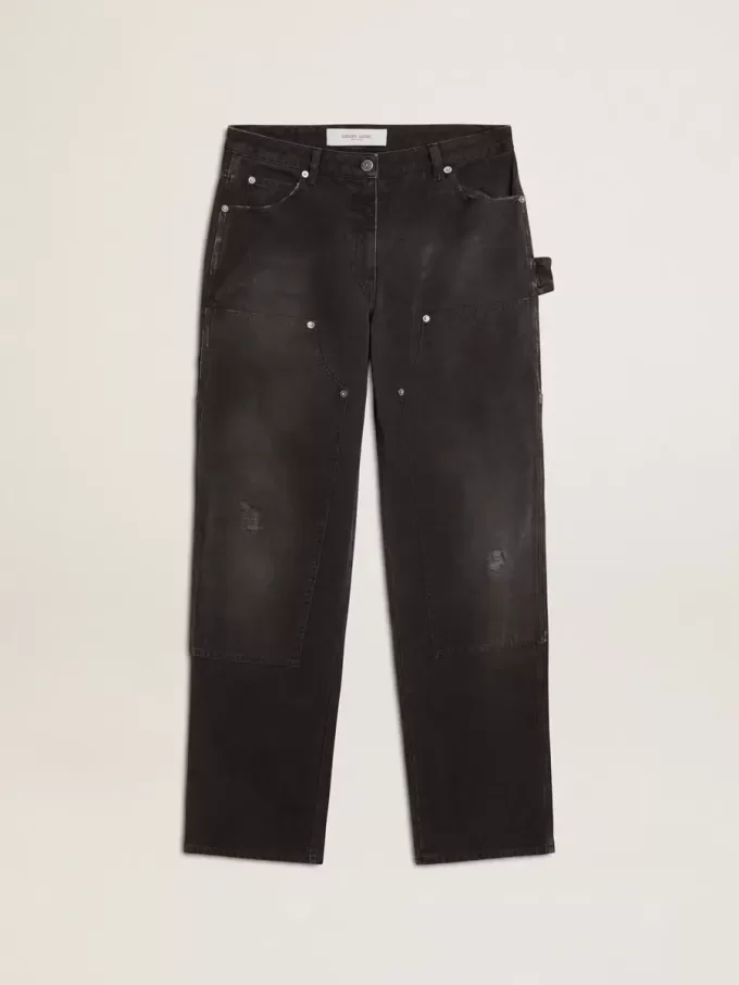 Damjeans i svart bomull med slitna detaljer och patchar fram Damjeans i svart bomull med slitna detaljer och patchar fram