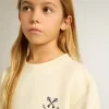 Flick-T-shirt i slitet vitt med broderi på framsidan och tryck på baksidan