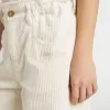 Flickbyxor i bred ribbstickning i krämfärg med broderi