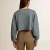 Kort sweatshirt i babyblått med slitna detaljer