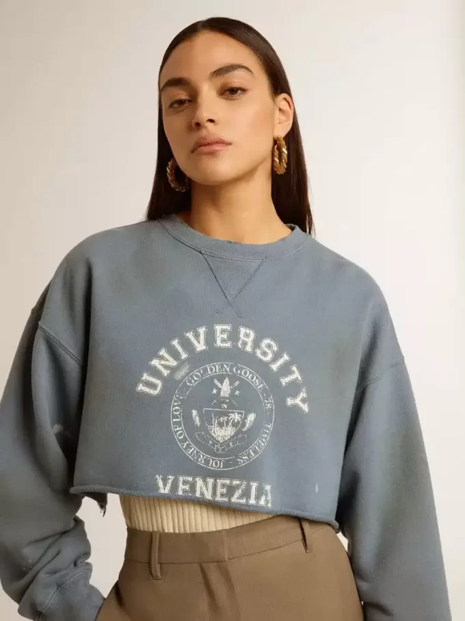 Kort sweatshirt i babyblått med slitna detaljer