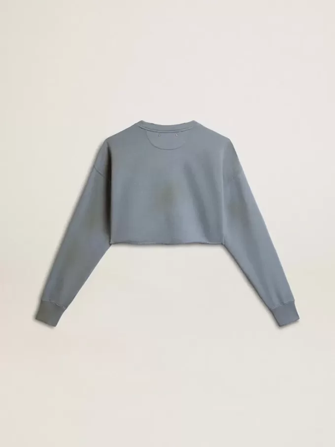 Kort sweatshirt i babyblått med slitna detaljer
