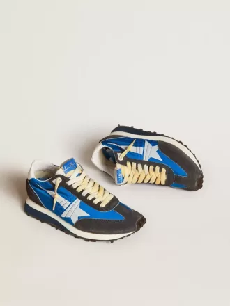 Marathon för damer med blå nylonöverdel och vit stjärna