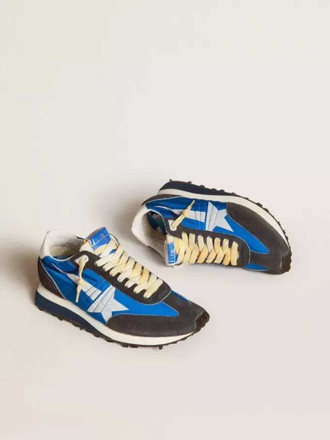 Marathon för damer med blå nylonöverdel och vit stjärna