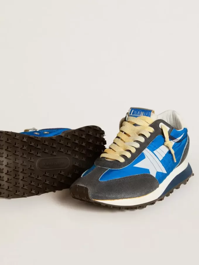 Marathon för damer med blå nylonöverdel och vit stjärna