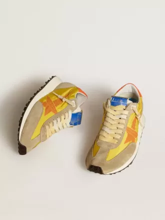 Marathon för damer med gul nylonöverdel och orange stjärna