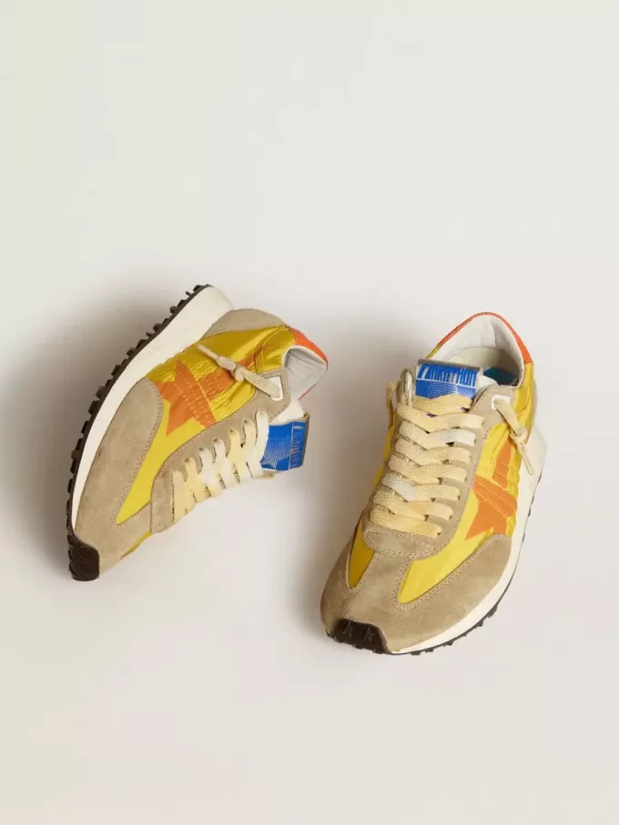 Marathon för damer med gul nylonöverdel och orange stjärna