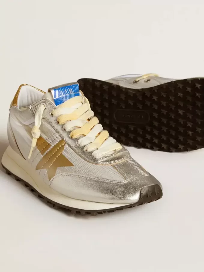 Marathon för damer med silverfärgat ripstop-nylonöverdel och guldstjärna