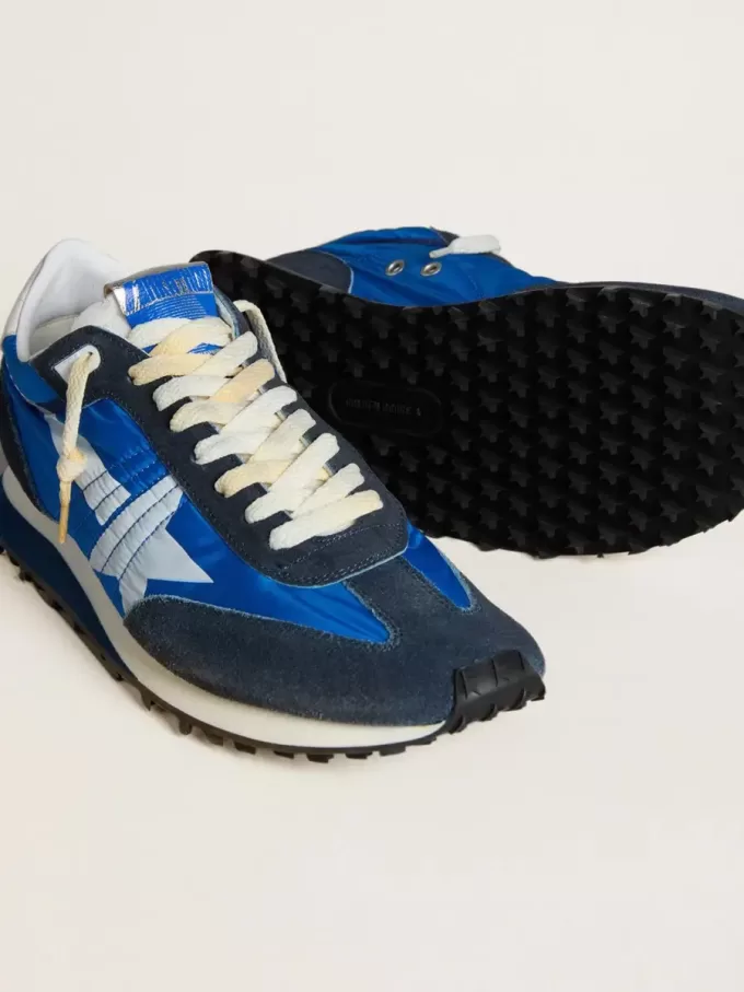 Marathon för herr med blå nylonöverdel och vit stjärna Marathon för herr med blå nylonöverdel och vit stjärna