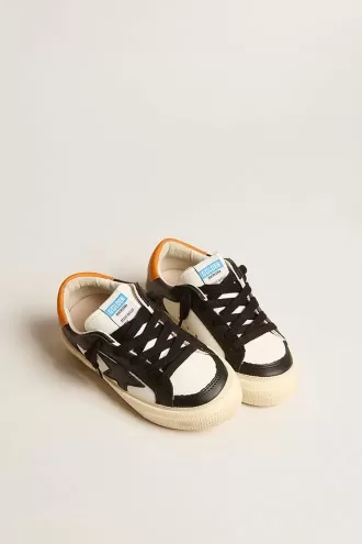 May Teen i svart och vitt läder med svart stjärna och orange hälflik