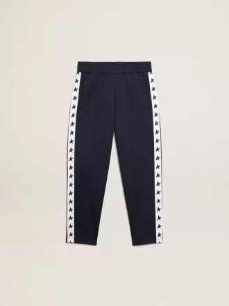 Mörkblå joggingbyxor med vit rand och kontrasterande stjärnor