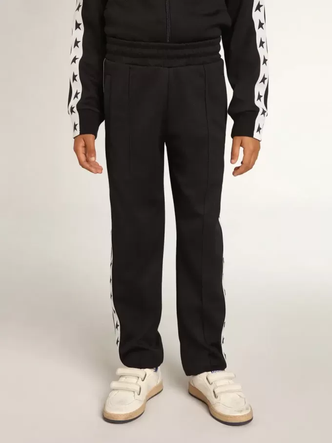 Mörkblå joggingbyxor med vit rand och kontrasterande stjärnor Mörkblå joggingbyxor med vit rand och kontrasterande stjärnor