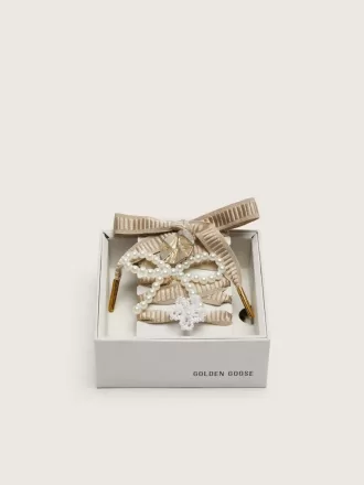 Skin ”Sparkling” beige broderade snören med applikationer av pärlor och guldberlocker