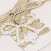 Skin ”Sparkling” beige broderade snören med applikationer av pärlor och guldberlocker