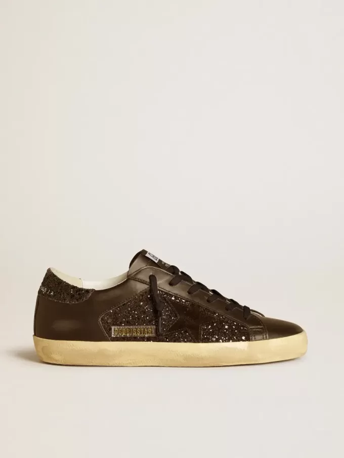 Super-Star för damer i svart glitter med svart mockastjärna och läderinsatser Super-Star för damer i svart glitter med svart mockastjärna och läderinsatser