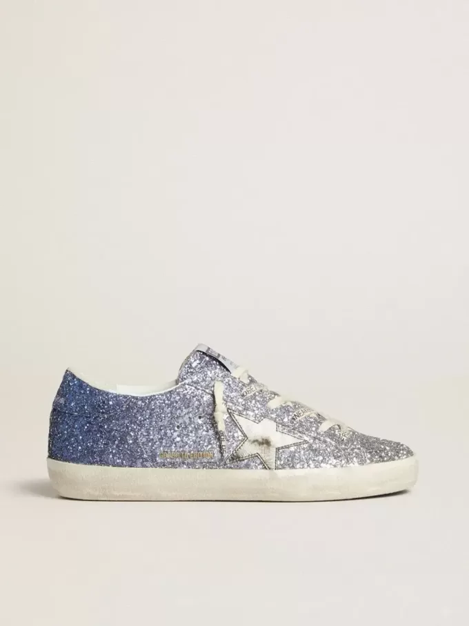 Super-Star LTD i flerfärgat glitter med silvermetallisk läderstjärna Super-Star LTD i flerfärgat glitter med silvermetallisk läderstjärna