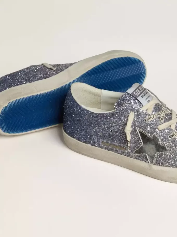 Super-Star LTD i flerfärgat glitter med silvermetallisk läderstjärna Super-Star LTD i flerfärgat glitter med silvermetallisk läderstjärna