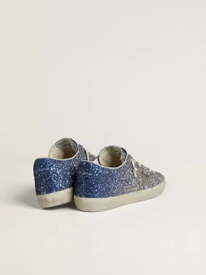 Super-Star LTD i flerfärgat glitter med silvermetallisk läderstjärna Super-Star LTD i flerfärgat glitter med silvermetallisk läderstjärna