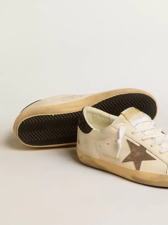 Super-Star LTD med laminerad läderstjärna och svart glitterhälflik Super-Star LTD med laminerad läderstjärna och svart glitterhälflik