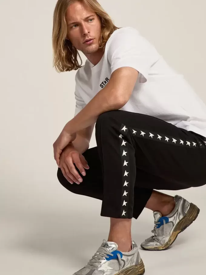 Svarta joggingbyxor för herr med vita stjärnor på sidorna Svarta joggingbyxor för herr med vita stjärnor på sidorna