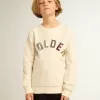 Sweatshirt i åldrat vitt med flerfärgad Golden-text på framsidan Sweatshirt i åldrat vitt med flerfärgad Golden-text på framsidan