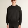 Unisex-tröja i sliten svart bomull med broderad logotyp Unisex-tröja i sliten svart bomull med broderad logotyp