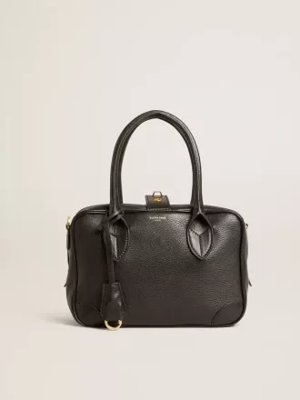 Vita Bag i svart fårskinn med gulddetaljer