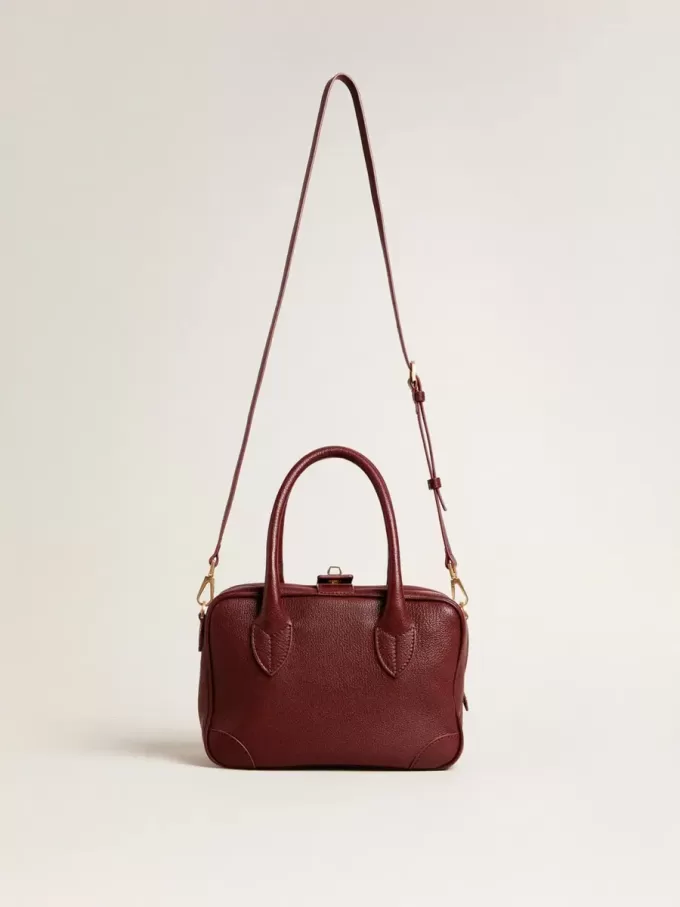 Vita Bag i vinrött läder med gulddetaljer Vita Bag i vinrött läder med gulddetaljer